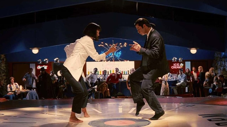 John Travolta as Vincent Vega and Uma Thurman as Mia Wallace in Pulp Fiction, dancing in the middle of a retro diner/club.