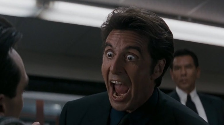 Al Pacino as Vincent Hanna in Heat, eyes wide and mouth agape as he makes a big point to the person he's talking to.