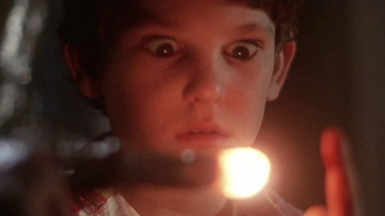 Elliot looking at E.T.'s glowing finger in E.T. The Extra-Terrestrial