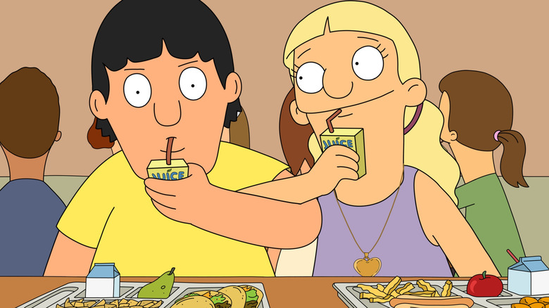 Gene drinks a juice box, arms linked with a girl drinking a juice box of her own