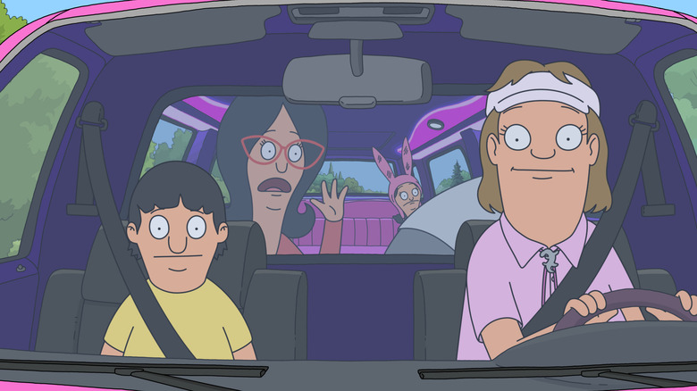 A woman in a visor drives a limo