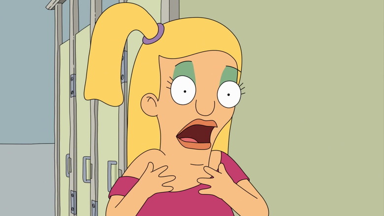 A blonde girl in a side ponytail talks emphatically