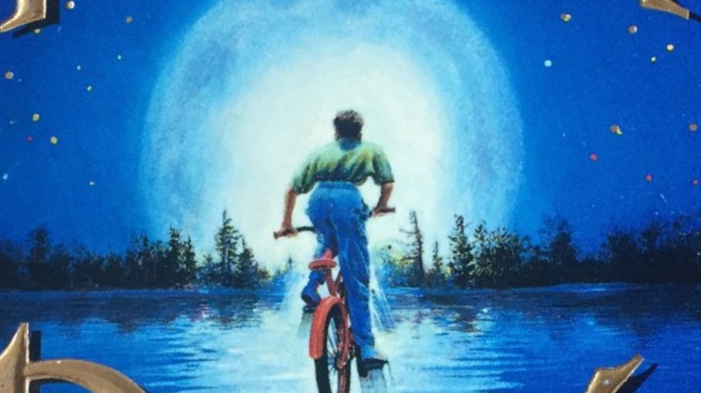 A young boy on his bike rides into the moonlight on Boy's Life