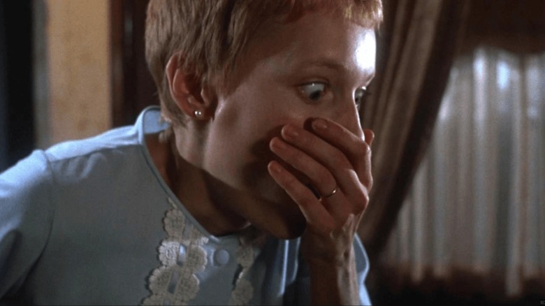 Rosemary Woodhouse (Mia Farrow) regards her horrible child in Rosemary's Baby