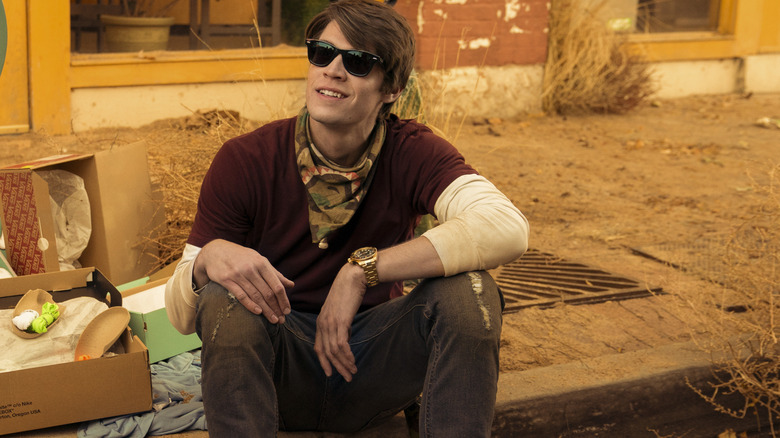 Josh (Colin Ford) sitting on the sidewalk on Daybreak