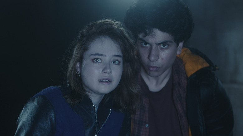 Lucy (Ruby Stokes) and George (Ali Hadji-Heshmati) next to each other in the darkness on Lockwood & Co.