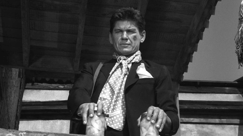 Man (Charles Bronson) holding two jars on The Twilight Zone