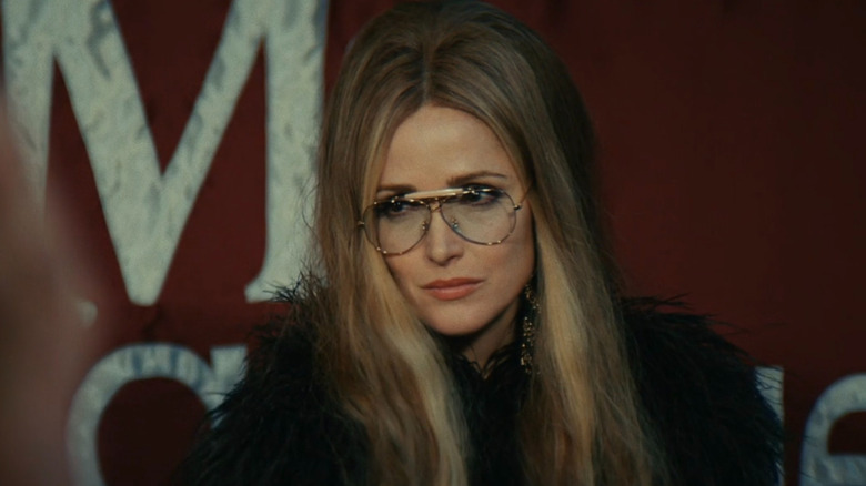 Gloria Steinem (Rose Byrne) wearing glasses in Mrs. America