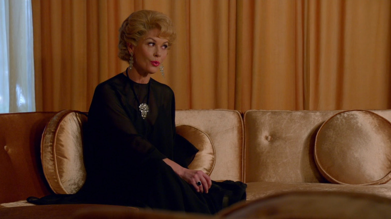 Olivia de Havilland (Catherine Zeta-Jones) sitting on a couch in Feud