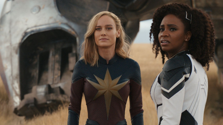 Carol Danvers/Captain Marvel (Brie Larson) and Monica Rambeau (Teyonah Parris) look out into a wheat field in The Marvels (2023)