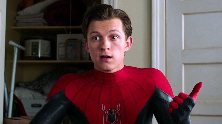 Spider-Man/Peter Parker (Tom Holland) standing in front of a closet unmasked in Spider-Man: Far From Home (2019)