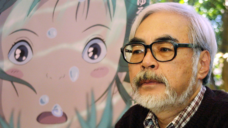 Hayao Miyazaki interviewed in front of Ghibli artwork