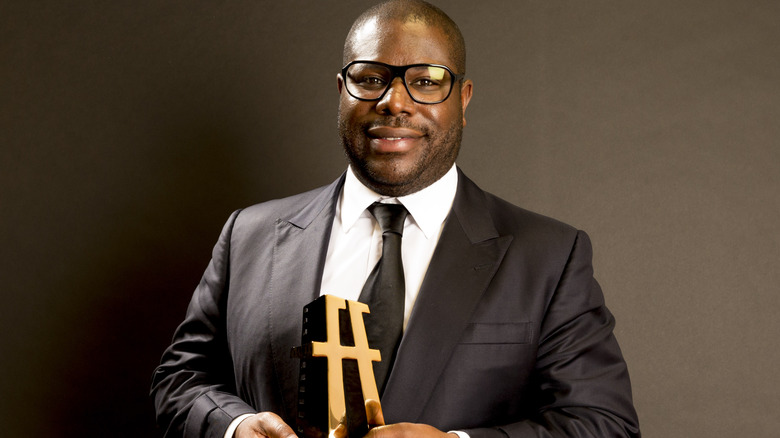 Steve McQueen holding an award