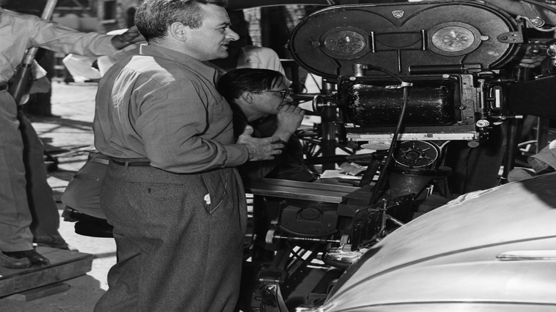 William Wyler standing behind camera on set of The Best Years of Our Lives