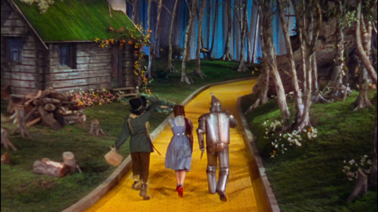 Dorothy (Judy Garland) skipping down yellow brick road in The Wizard of Oz