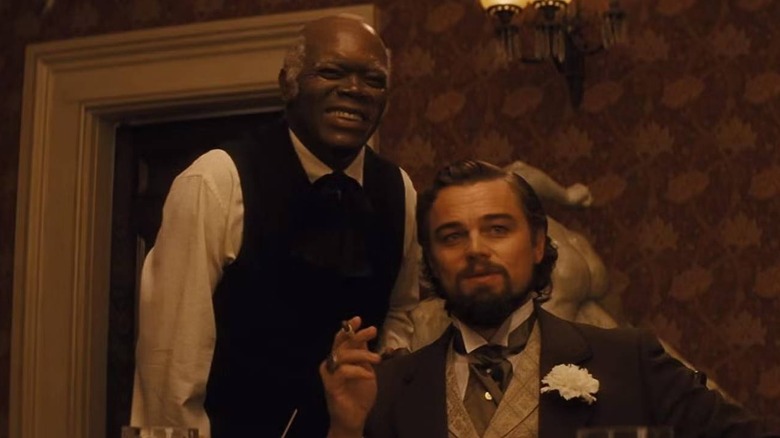 Stephen (Samuel L. Jackson) laughing next to Calvin Candie (Leonardo DiCaprio) in Django Unchained