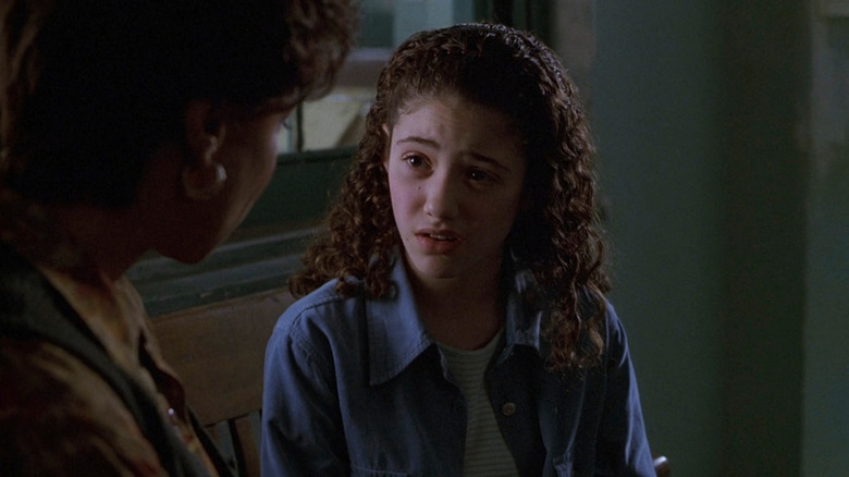 Emmy Rossum as Alison sitting on bench in Law & Order
