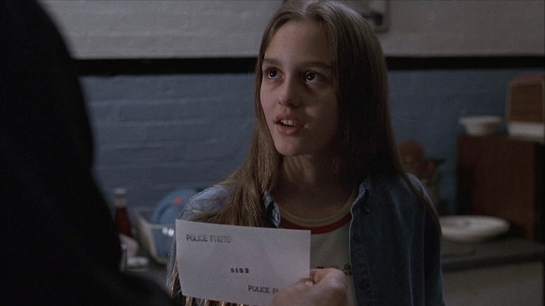 Leighton Meester as Alyssa looking at photo in Law & Order
