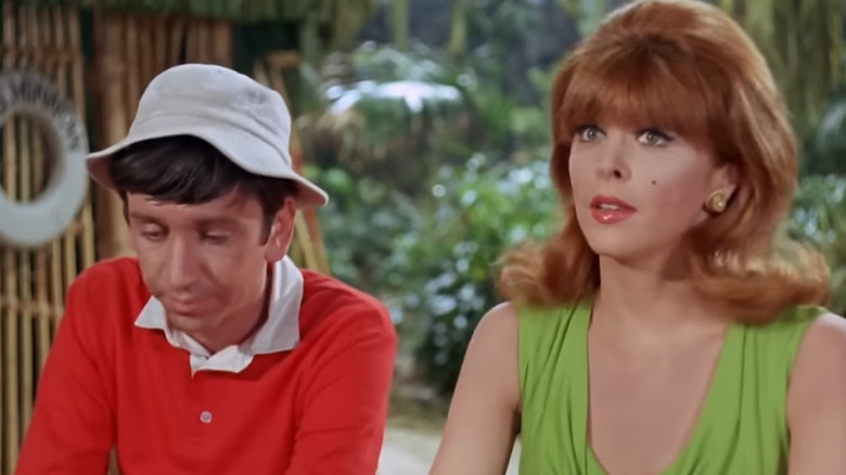 Gilligan (Bob Denver) sitting with Ginger (Tina Louise) on Gilligan's Island
