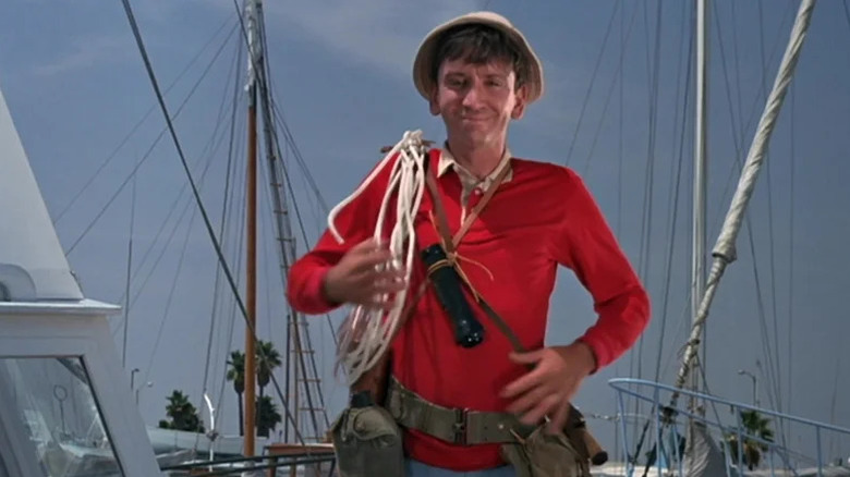 Gilligan (Bob Denver) carrying rope on a boat on Gilligan's Island