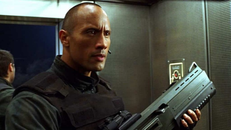 Dwayne Johnson as Sarge holding a gun in Doom