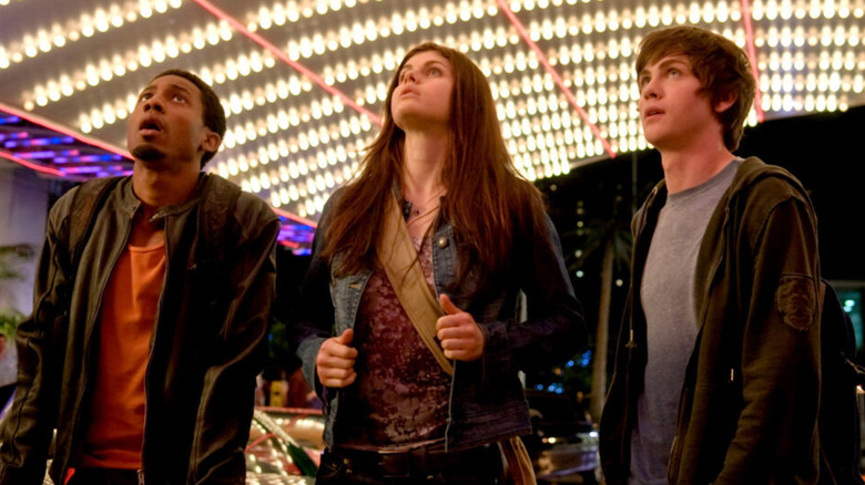 Brandon T. Jackson as Grover, Alexandra Daddario as Annabeth, and Logan Lerman as Percy standing outside a casino in The Lightning Thief