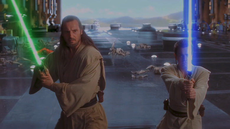 Liam Neeson as Qui Gon Jin and Ewan McGregor as Obi-Wan Kenobi ready for a lightsaber fight in The Phantom Menace