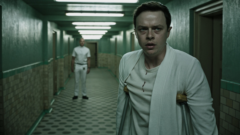 Lockhart (Dane DeHaan) looking worried in wellness facility in A Cure for Wellness