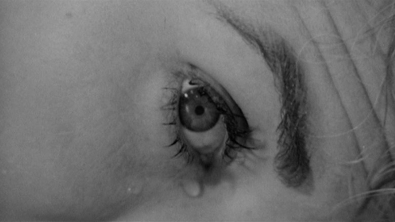 An extreme closeup of the eye of Janet Leigh as Marion Crane in Psycho, lying on the bathroom floor