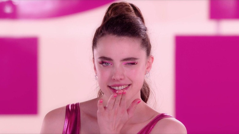Sue (Margaret Qualley) winking and blowing a kiss to the camera, in The Substance