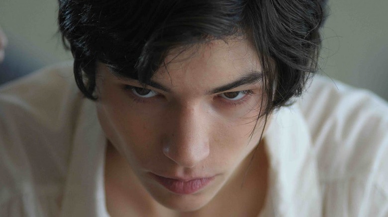 Close-up of Ezra Miller as Kevin looking down in a Kubrick Stare-esque shot in We Need to Talk About Kevin