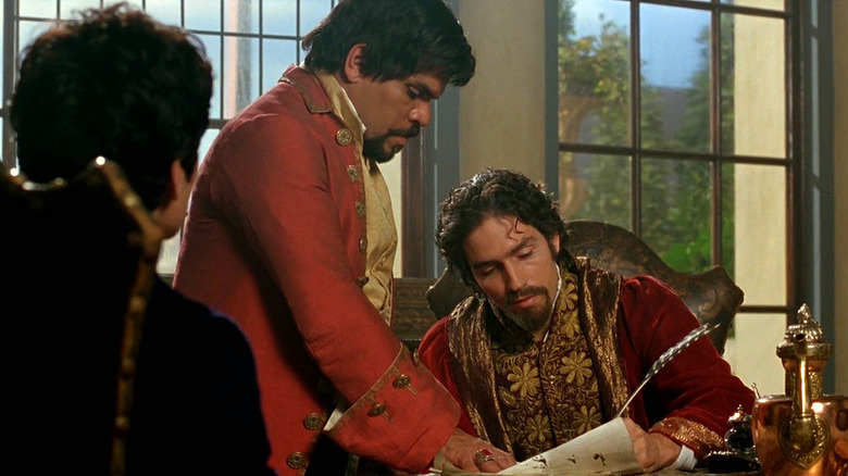 Jim Caviezel signs document with quill