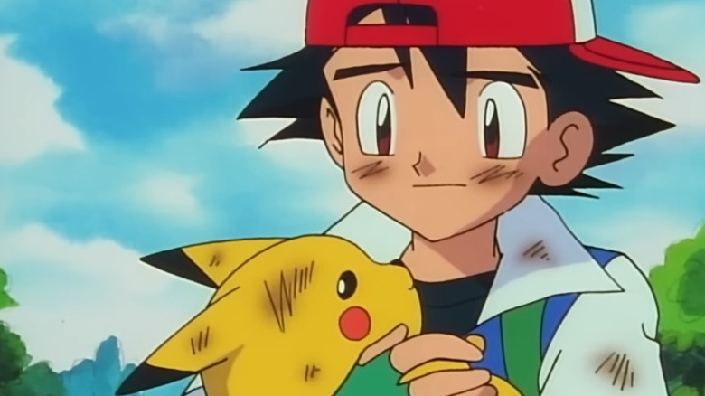 Ash Ketchum cradling Pikachu in his arms on Pokémon