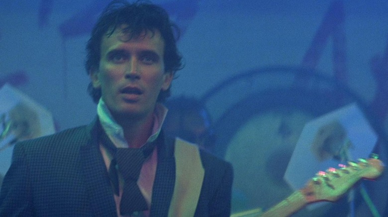 Buckaroo Banzai (Peter Weller) plays guitar in The Adventures of Buckaroo Banzai Across the 8th Dimension