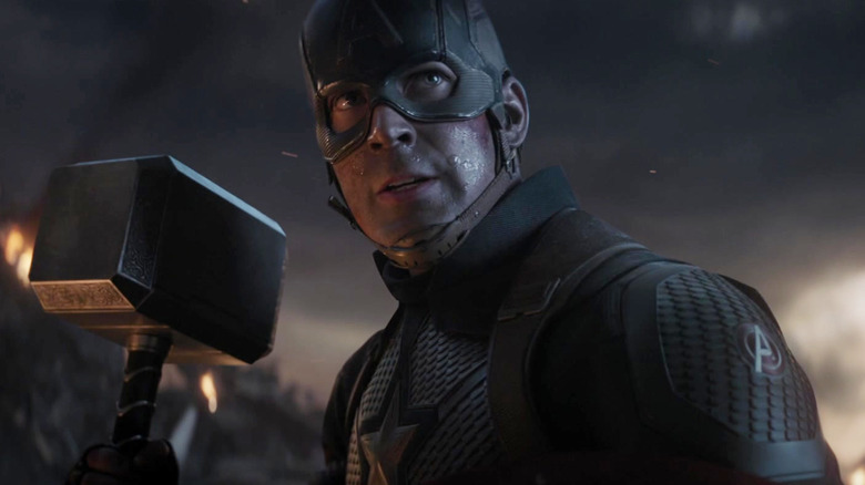 Chris Evans as Captain America, holding Mjlonir and his shield, Avengers: Endgame