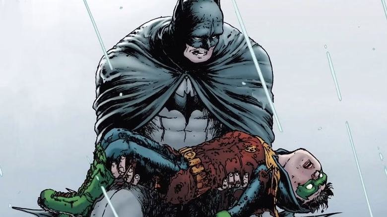 Batman holds Robin's bleeding corpse