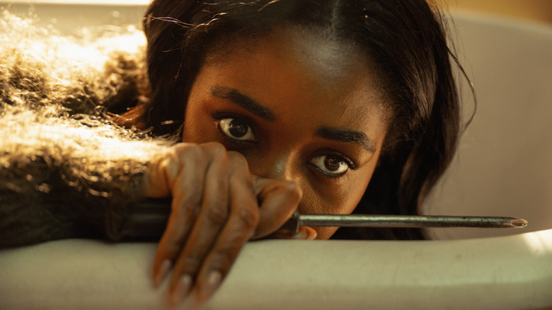 Ayo Edebiri as Ariel Ecton, holding a screwdriver in Opus