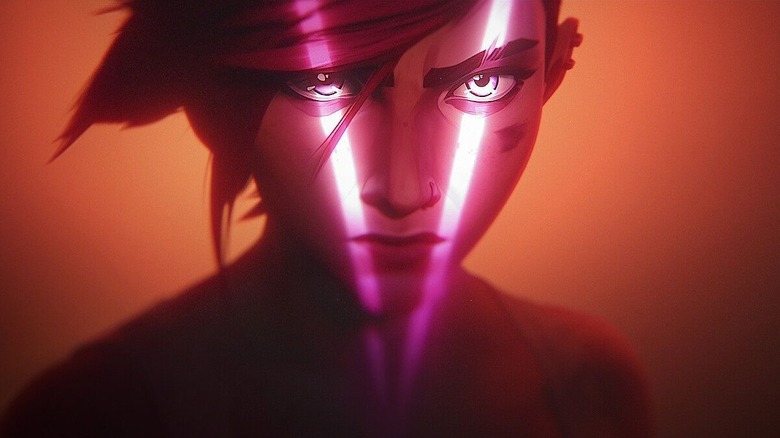 Vi with a glowing pink V illuminating her face in Arcane