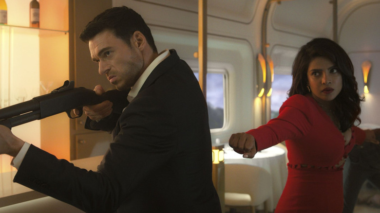 Richard Madden as Mason with a shotgun and Priyanka Chopra as Nadia in Citadel
