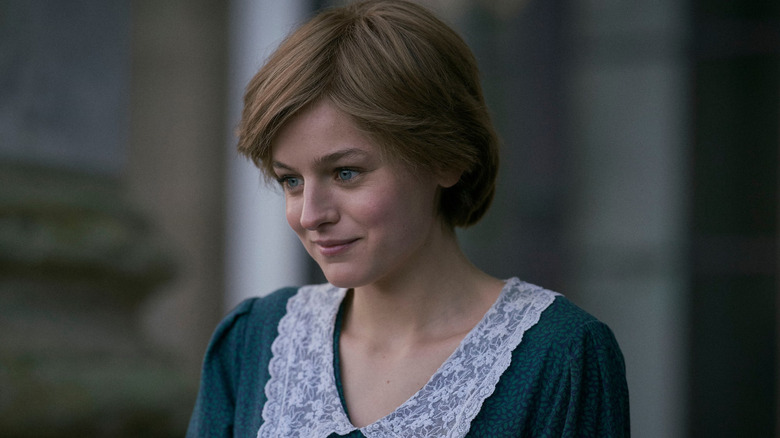 Emma Corrin as Princess Diana smiling in The Crown