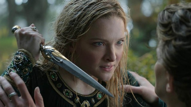 Morfydd Clark as Galadriel holding a dagger in Lord of the Rings: The Rings of Power