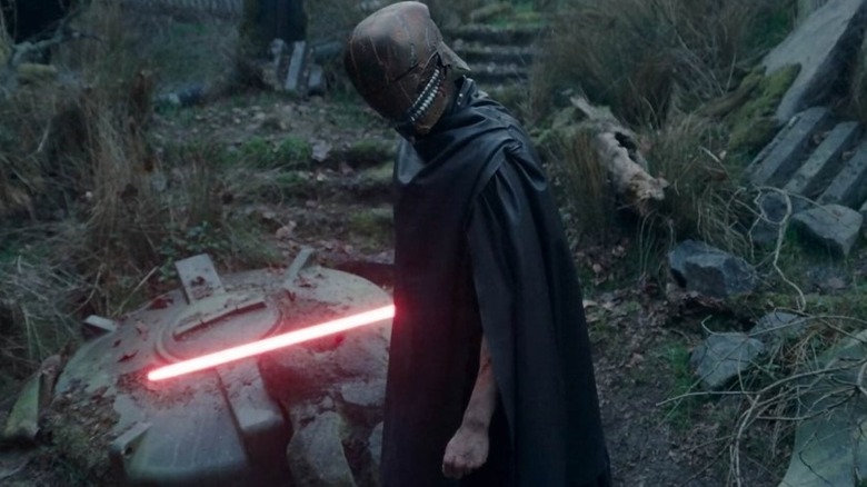 The Stranger (Manny Jacinto) wielding a red lightsaber on Star Wars: The Acolyte