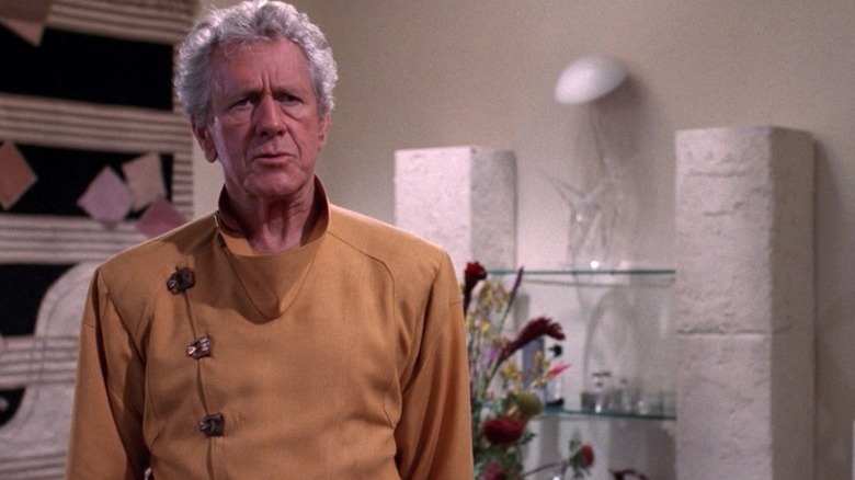Kevin Uxbridge (John Anderson) stands in his living room in Star Trek: The Next Generation