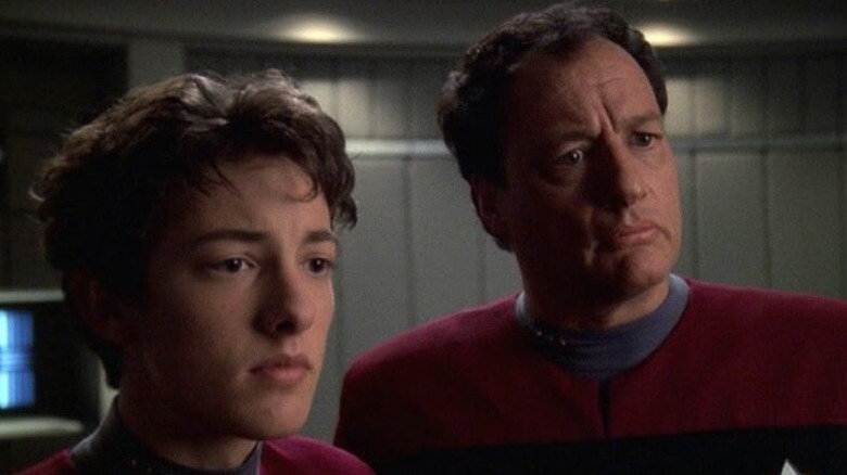 Q Junior (Keegan de Lancie) stands next to Q (John de Lancie) in Star Trek: Voyager