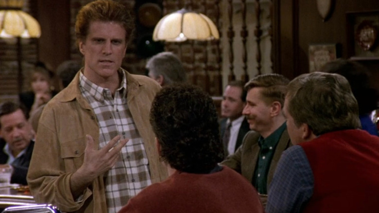 Sam Malone (Ted Danson) talking to customers on Cheers