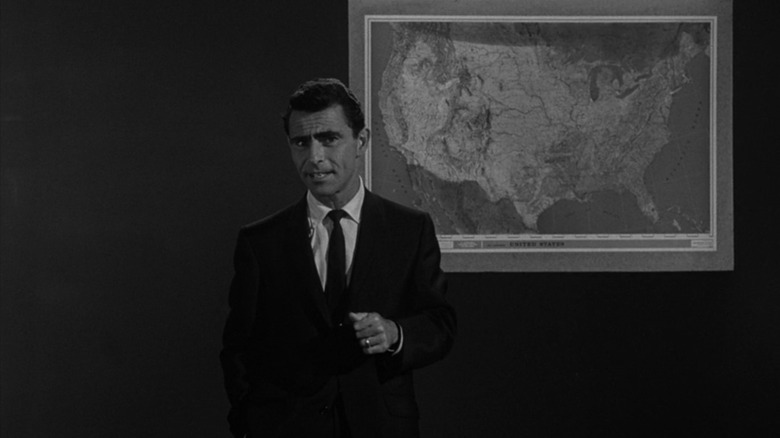 Rod Serling standing in front of a map of the United States on The Twilight Zone