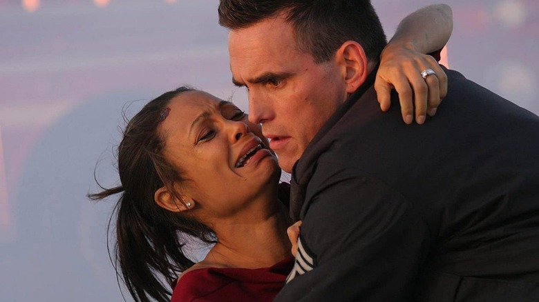Matt Dillon and Thandiwe Newton as Matt Dillon as Sergeant John Ryan and Christine Thayer, embracing in Crash.
