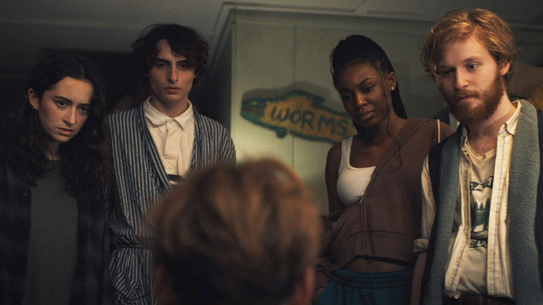 Jason and his camp counselor colleagues looking at a sitting Bobby in "Hell of a Summer"