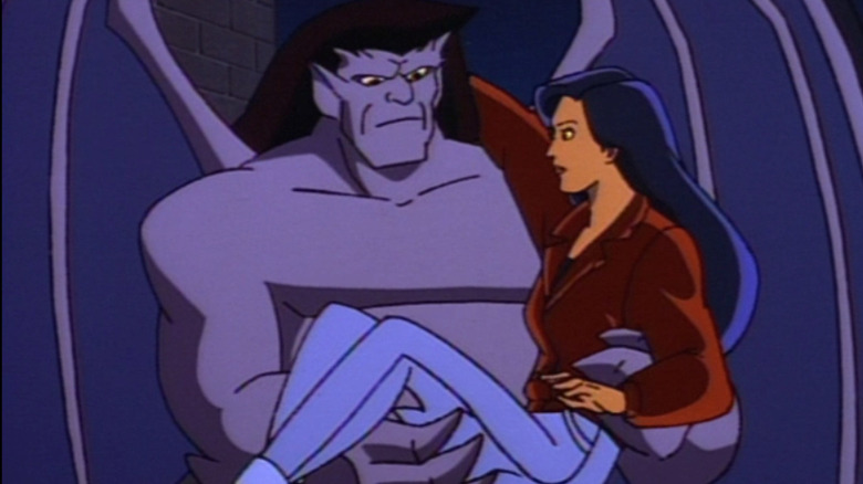 Goliath stands while holding Elisa Maza in his arms on Gargoyles