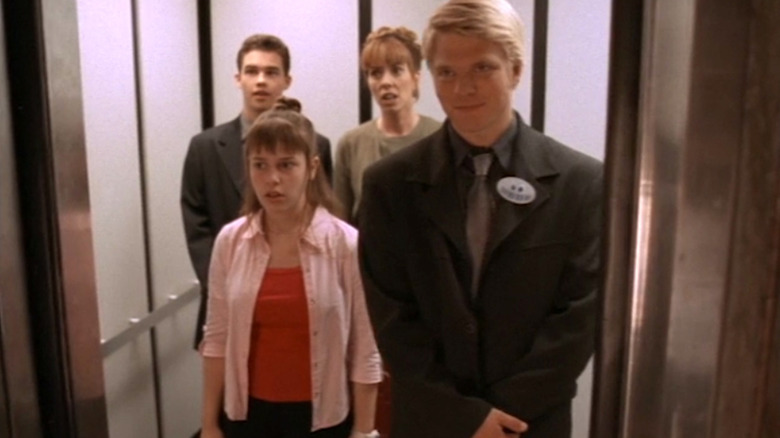 Cara DeLizia as Fiona Phillips stands in an elevator with Patrick Levis as Jack Phillips, Mackenzie Phillips as Molly Phillips, and David Paetkau as Brent on So Weird